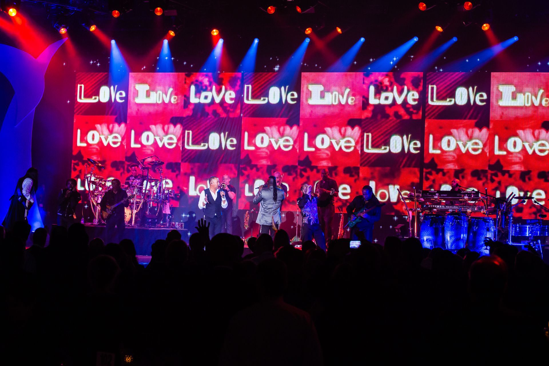 A stage with a large screen that says love on it