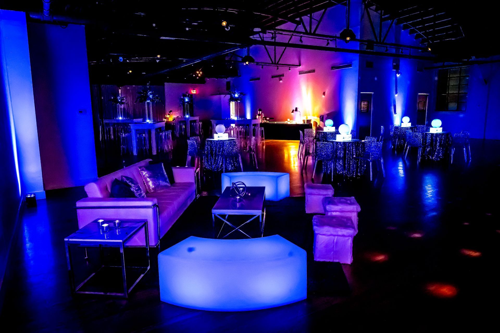 A room with a lot of furniture and blue lights