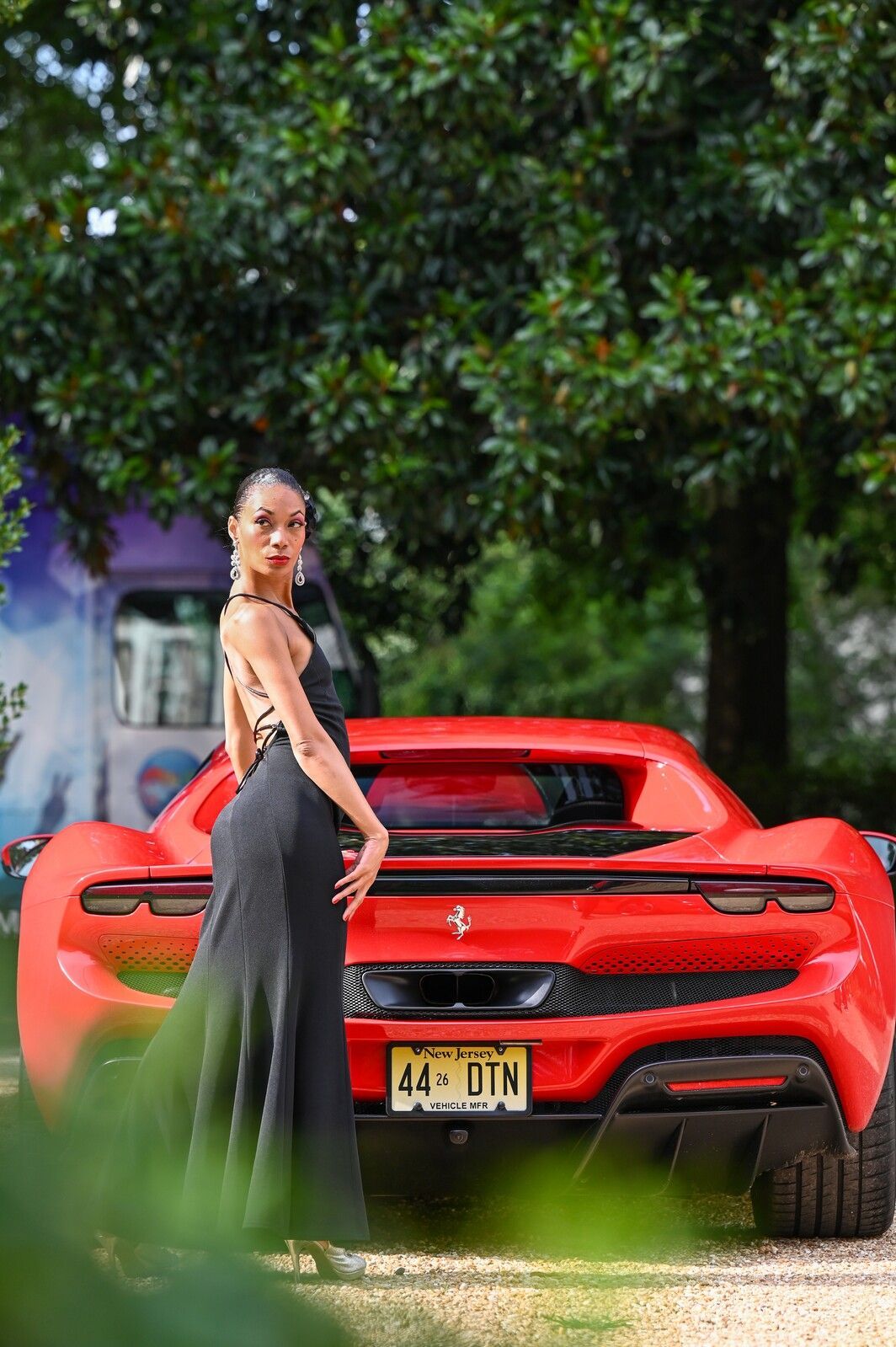 model standing in front of ferrari