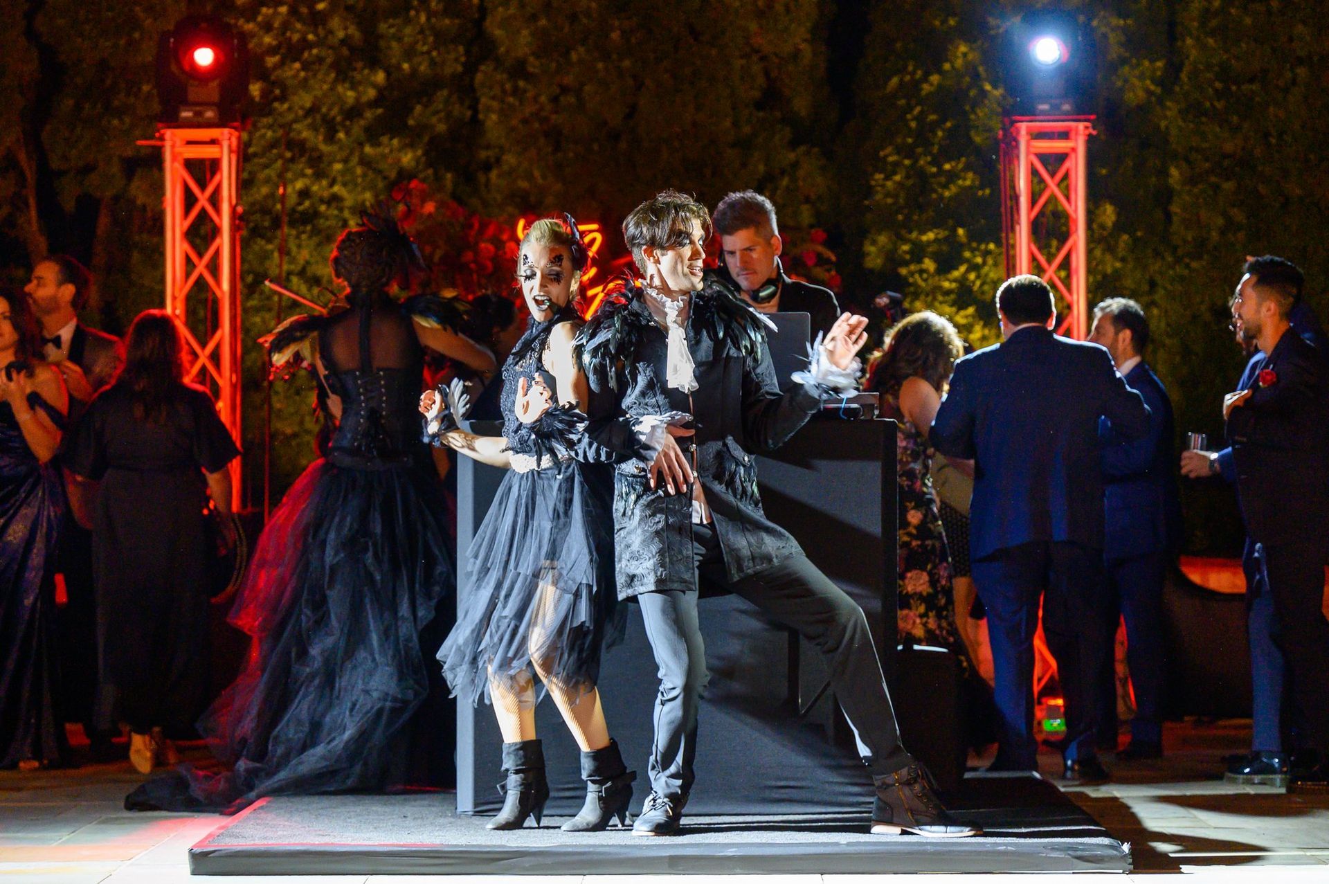 A group of people are dancing on a stage at a party.