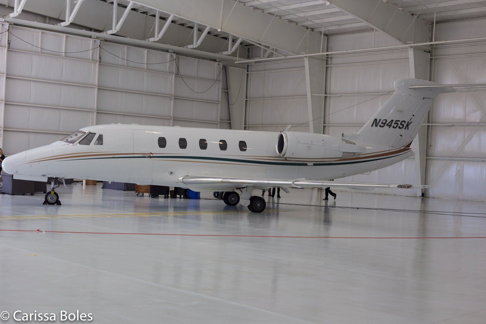 a private jet is parked inside of a hangar