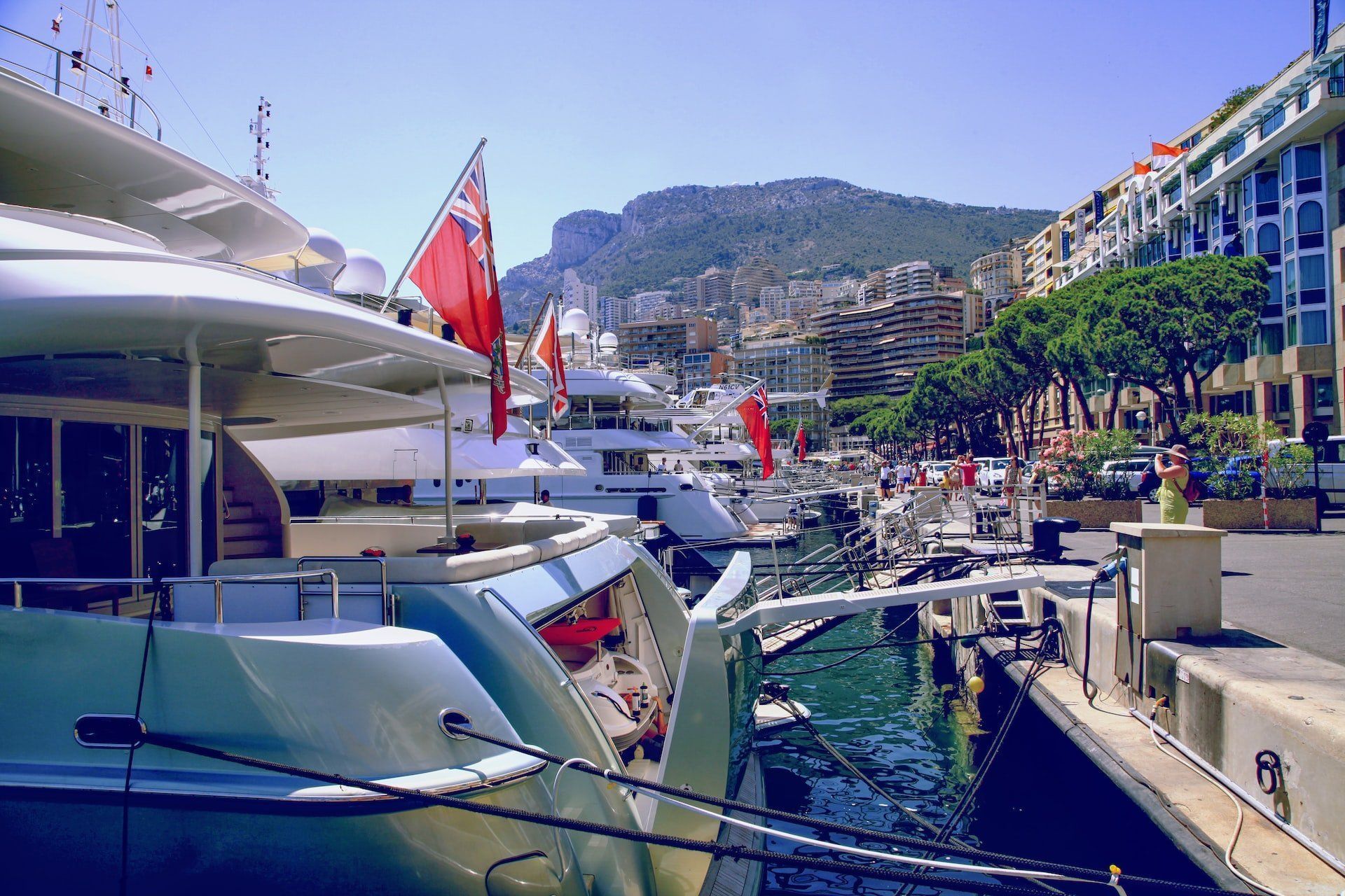 a large yacht is docked in a harbor with mountains in the background