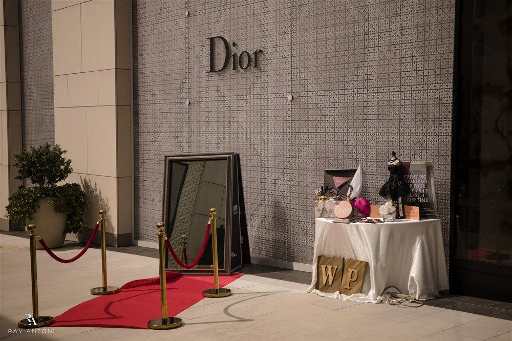 There is a red carpet in front of a dior store.