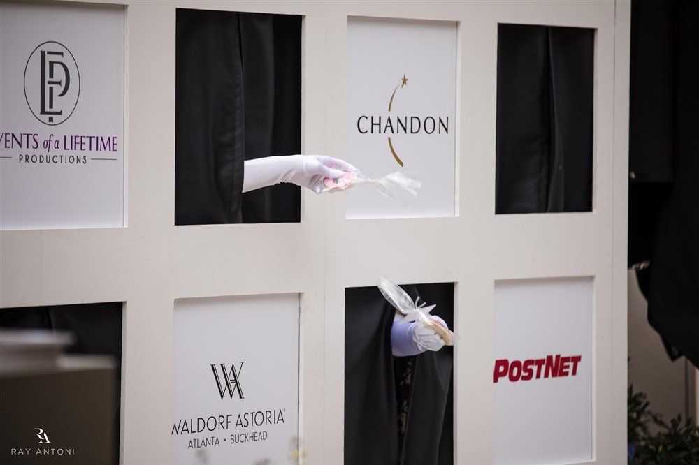 A person is holding a feather in front of a sign that says postnet