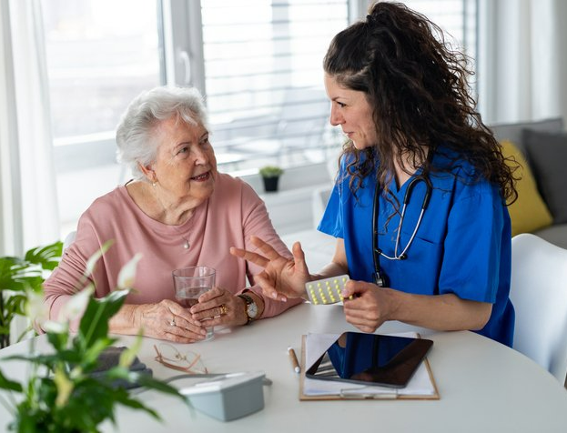 Female nurse explaining medicine pills to a senior woman – Alfredton, VIC – Ballarat Nurses