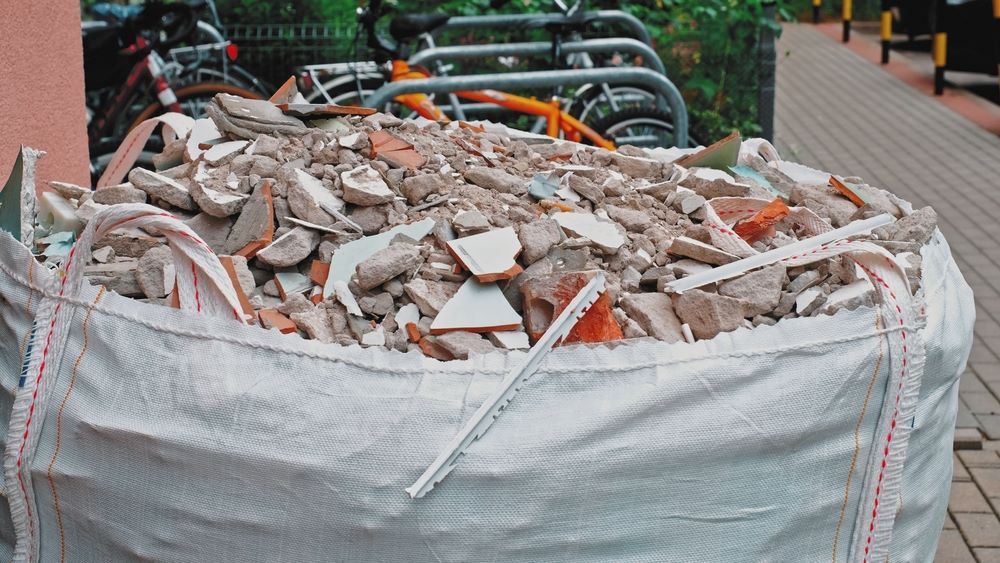 A Large White Bag Filled with Bricks Is Sitting on A Sidewalk — Hyper Cut & Drill in Lake Macquarie, NSW