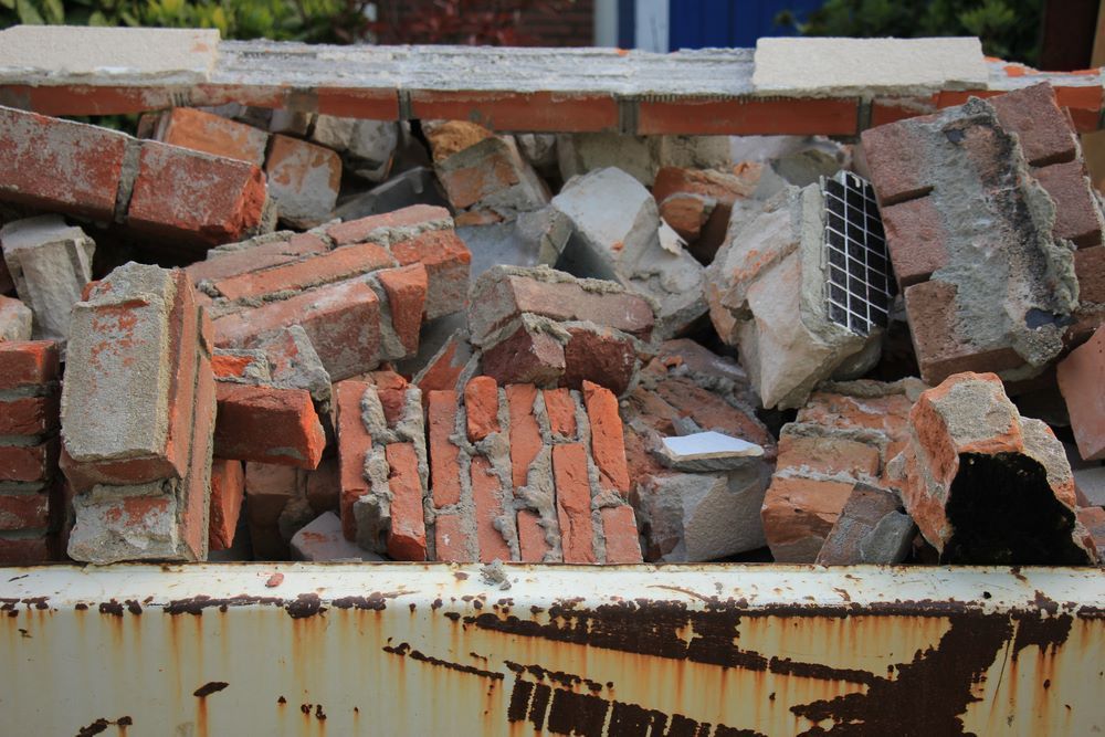 A Rusty Dumpster Filled with Bricks and Concrete — Hyper Cut & Drill in Wyong, NSW
