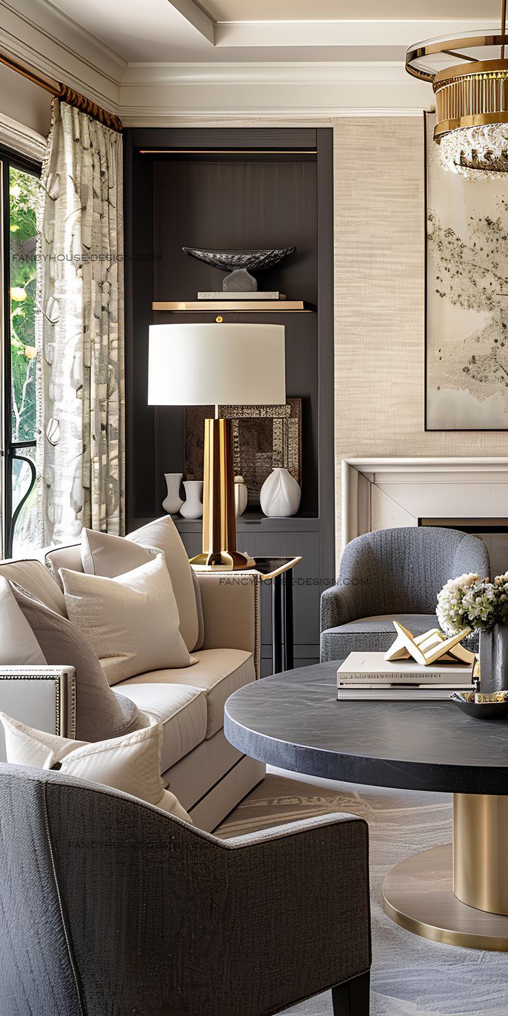 Living room with neutral tones; sofa, round table, gold accents, and a built-in display shelf.