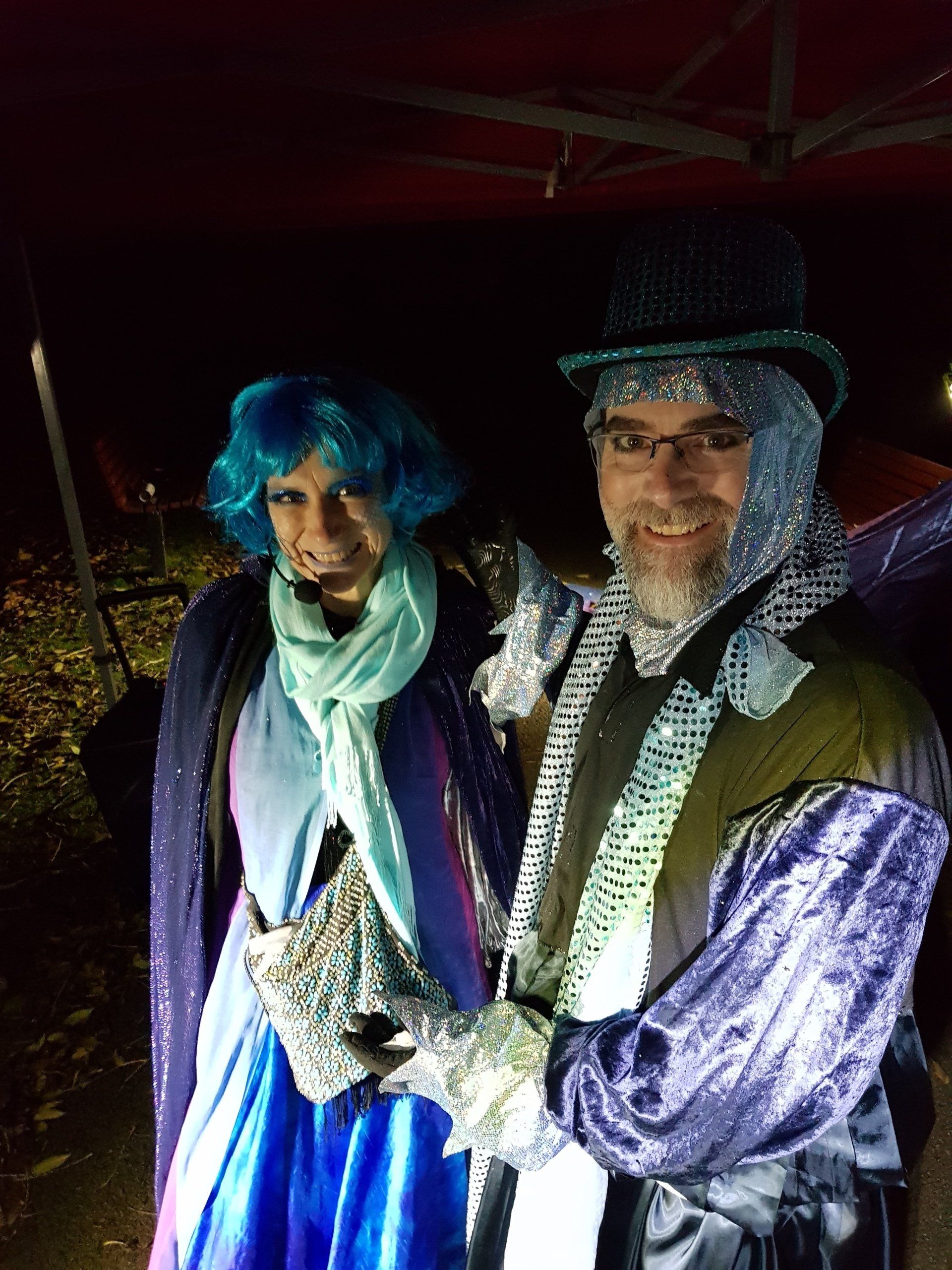 A man and a woman are dressed in costumes and posing for a picture.