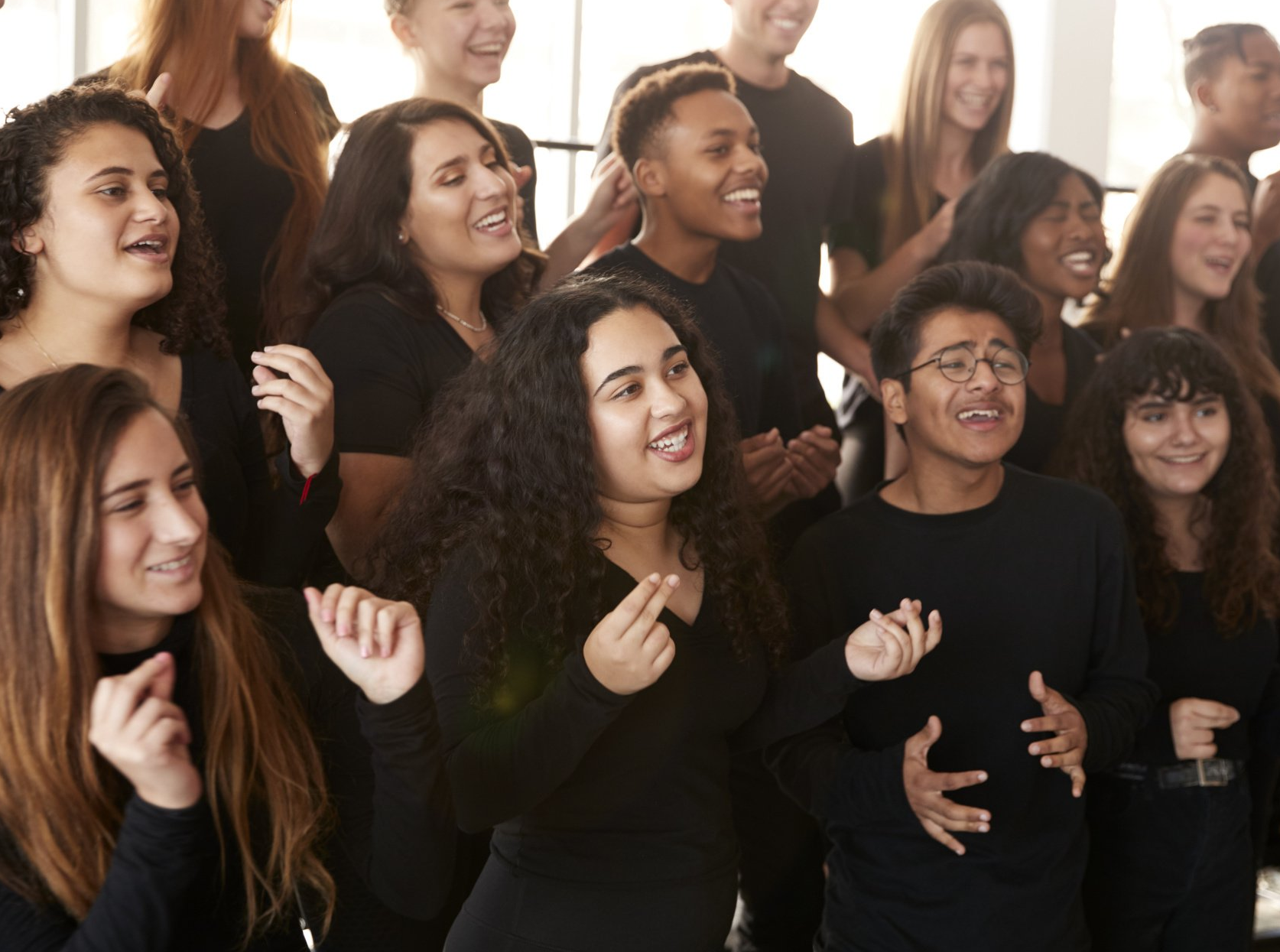 A group of young people are singing together in a choir.