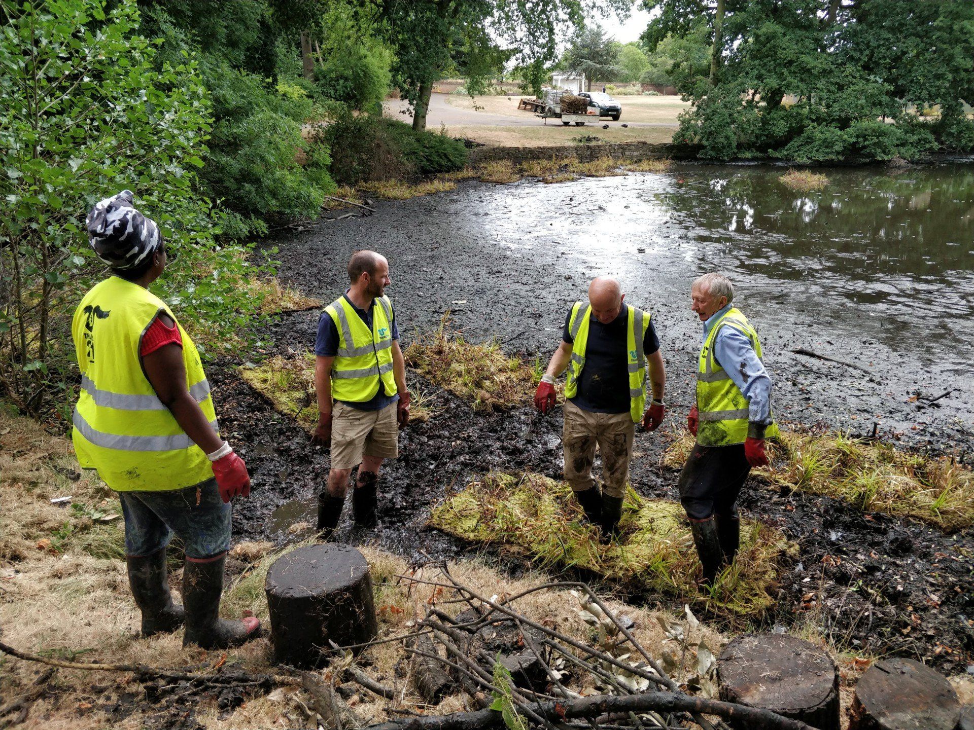 A group of people are standing next to a body of water.