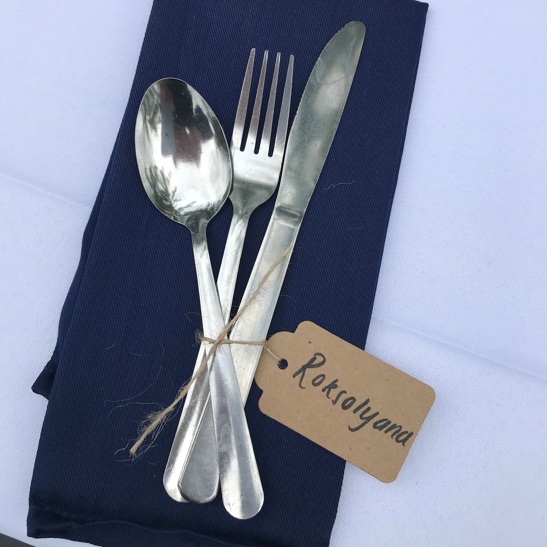 Silverware on a napkin with a tag that says roksolyana