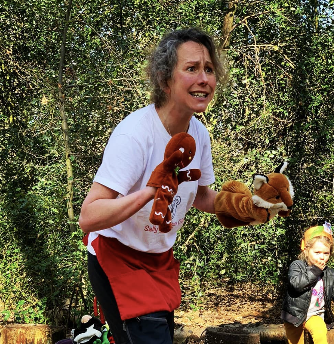 A woman in a white shirt is holding a stuffed animal in her hands