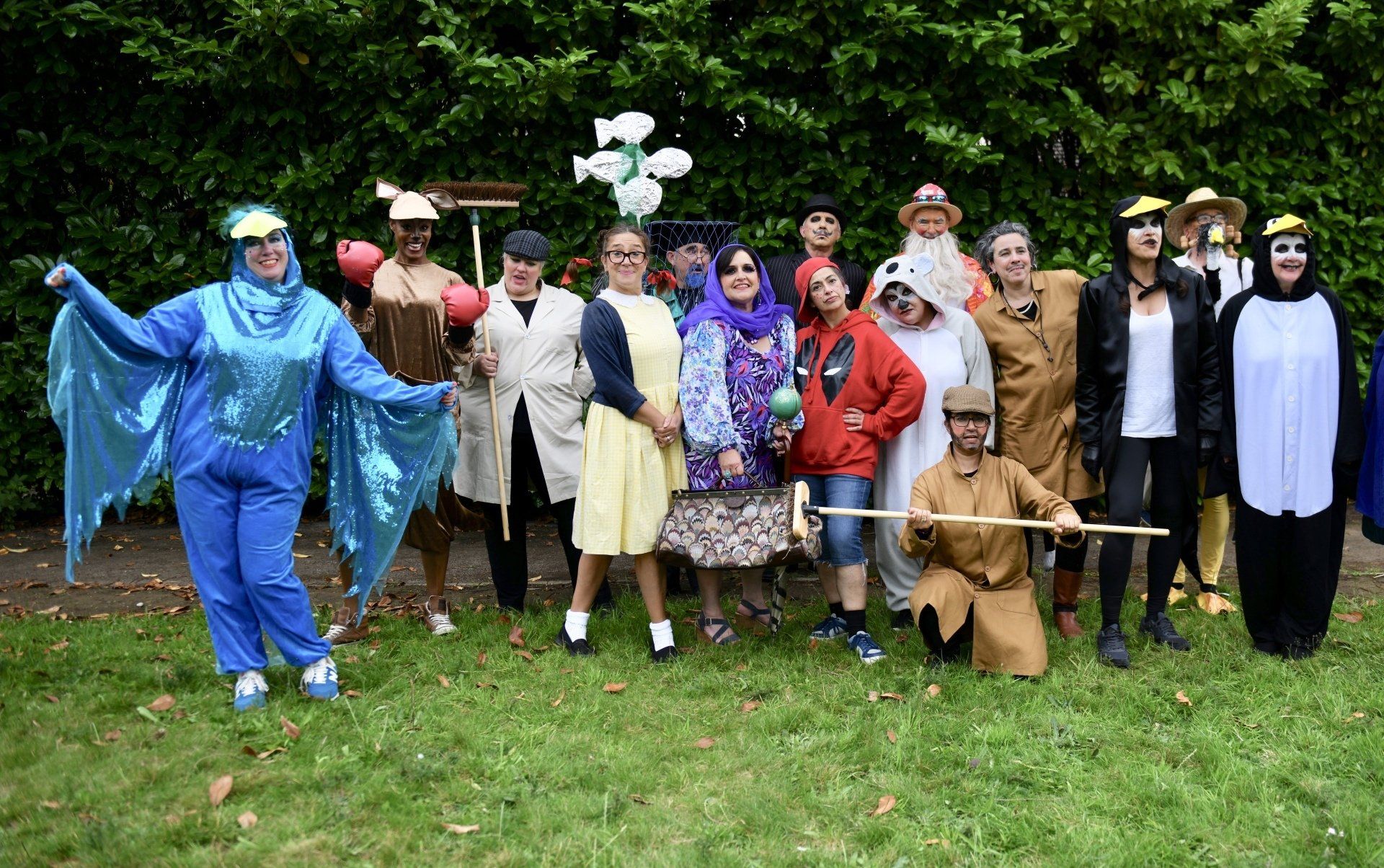 A group of people dressed in costumes are posing for a picture.