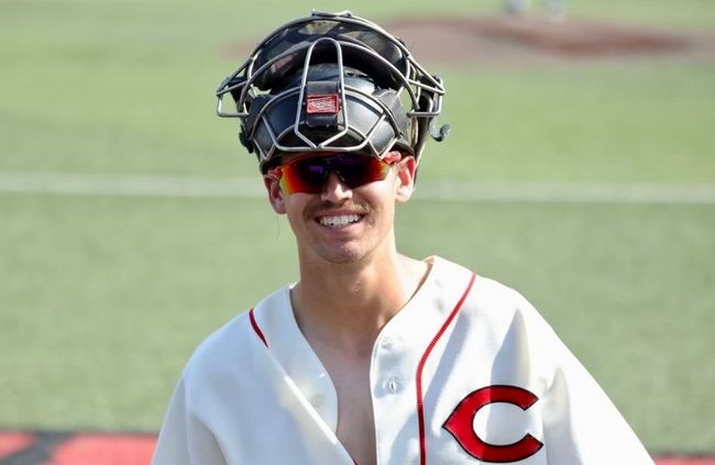 A man wearing a baseball uniform with the letter c on it