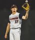 A baseball player is holding a glove and a ball in his hand.