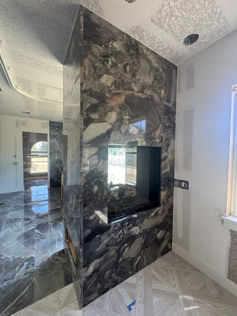 The light quartz top really complements the darker tiles in this master bathroom. 