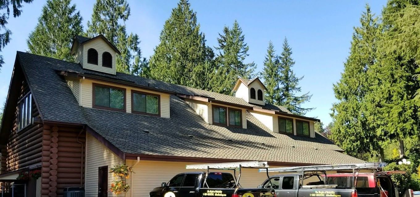 A large house with two trucks parked in front of it.