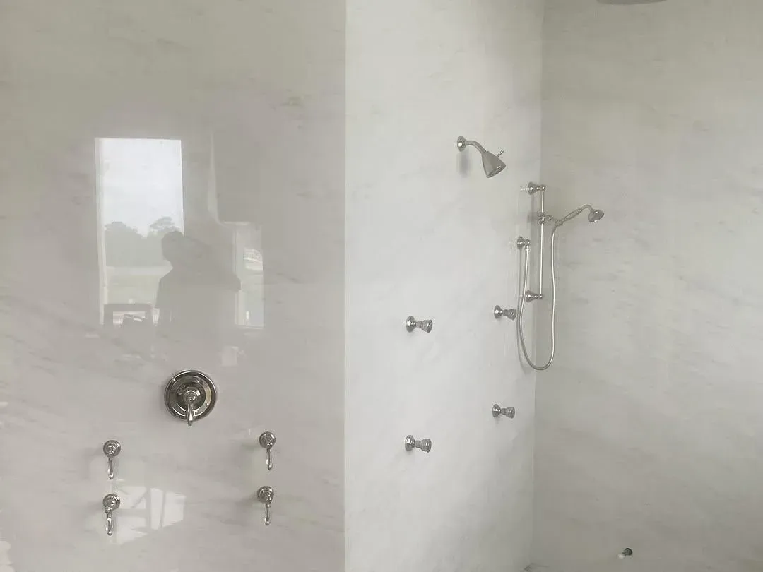 A bathroom with a shower , tub , and mirror.