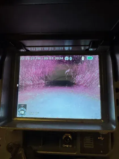 A camera is taking a picture of a pipe.