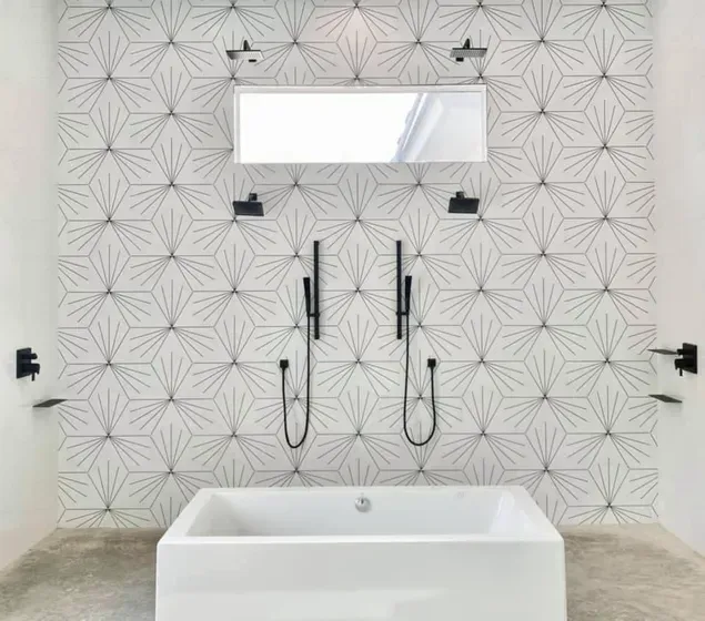 A bathroom with a bathtub , shower , and mirror.