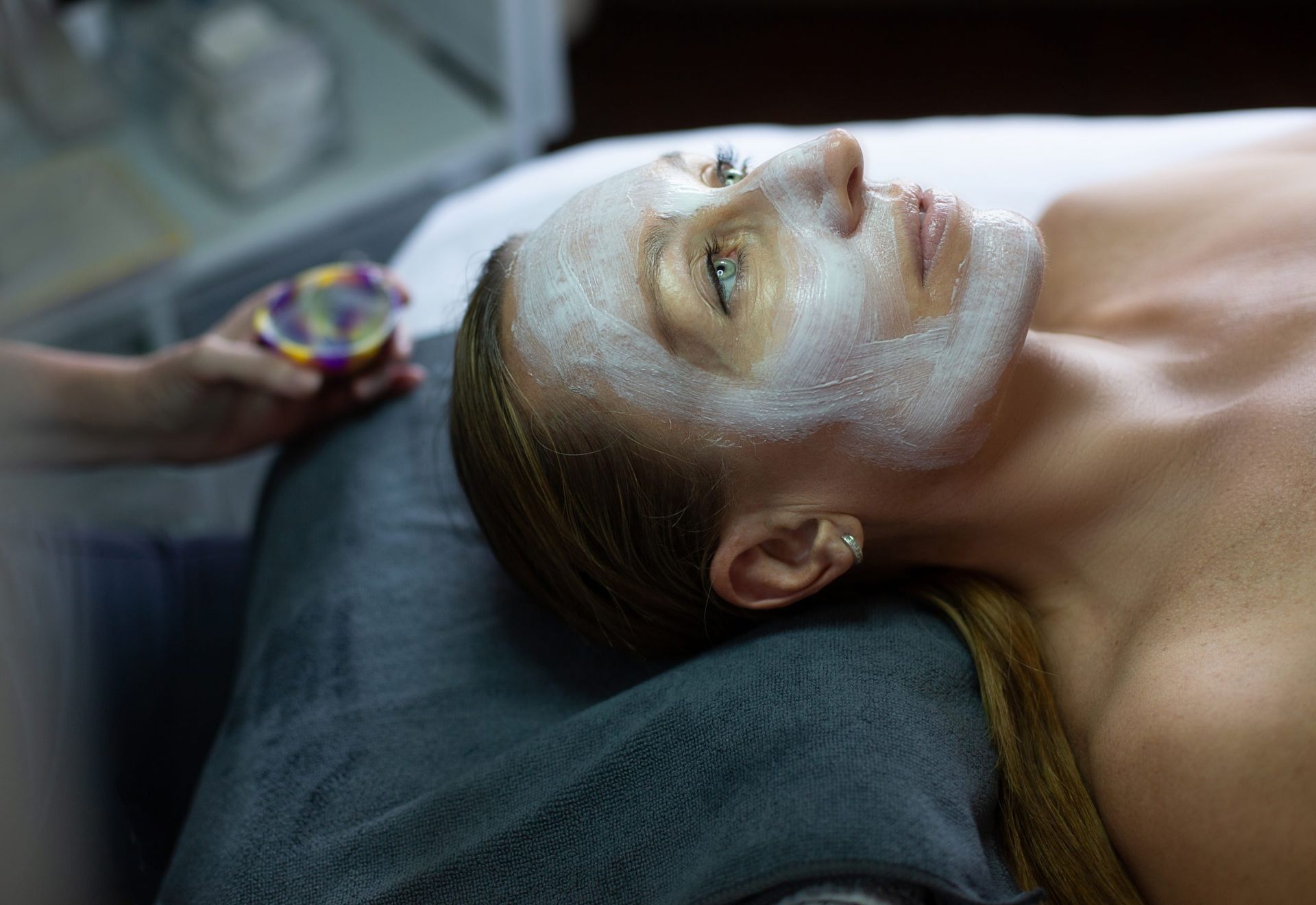 A woman is getting a facial treatment at a spa.