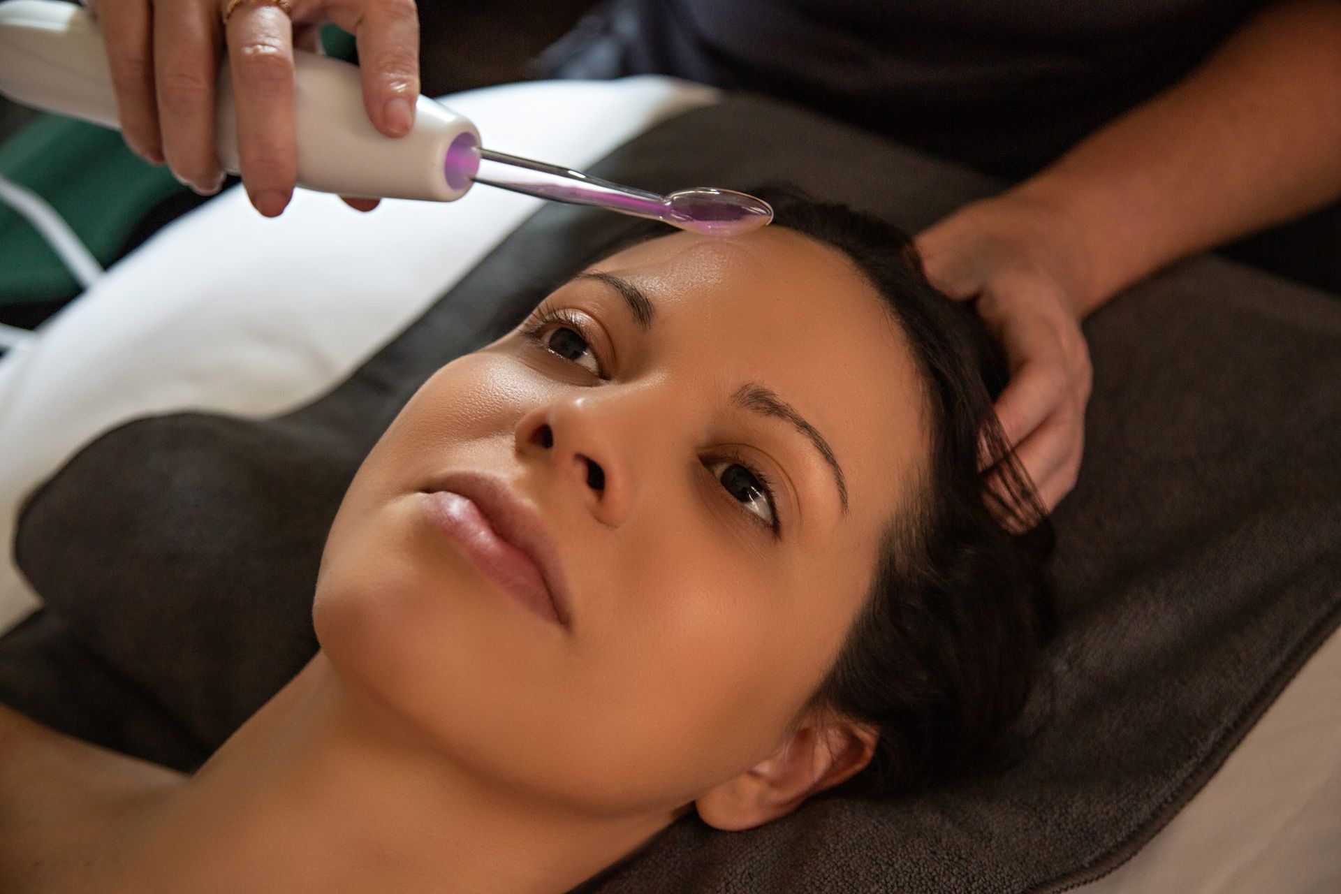 A woman is getting a facial treatment at a spa.