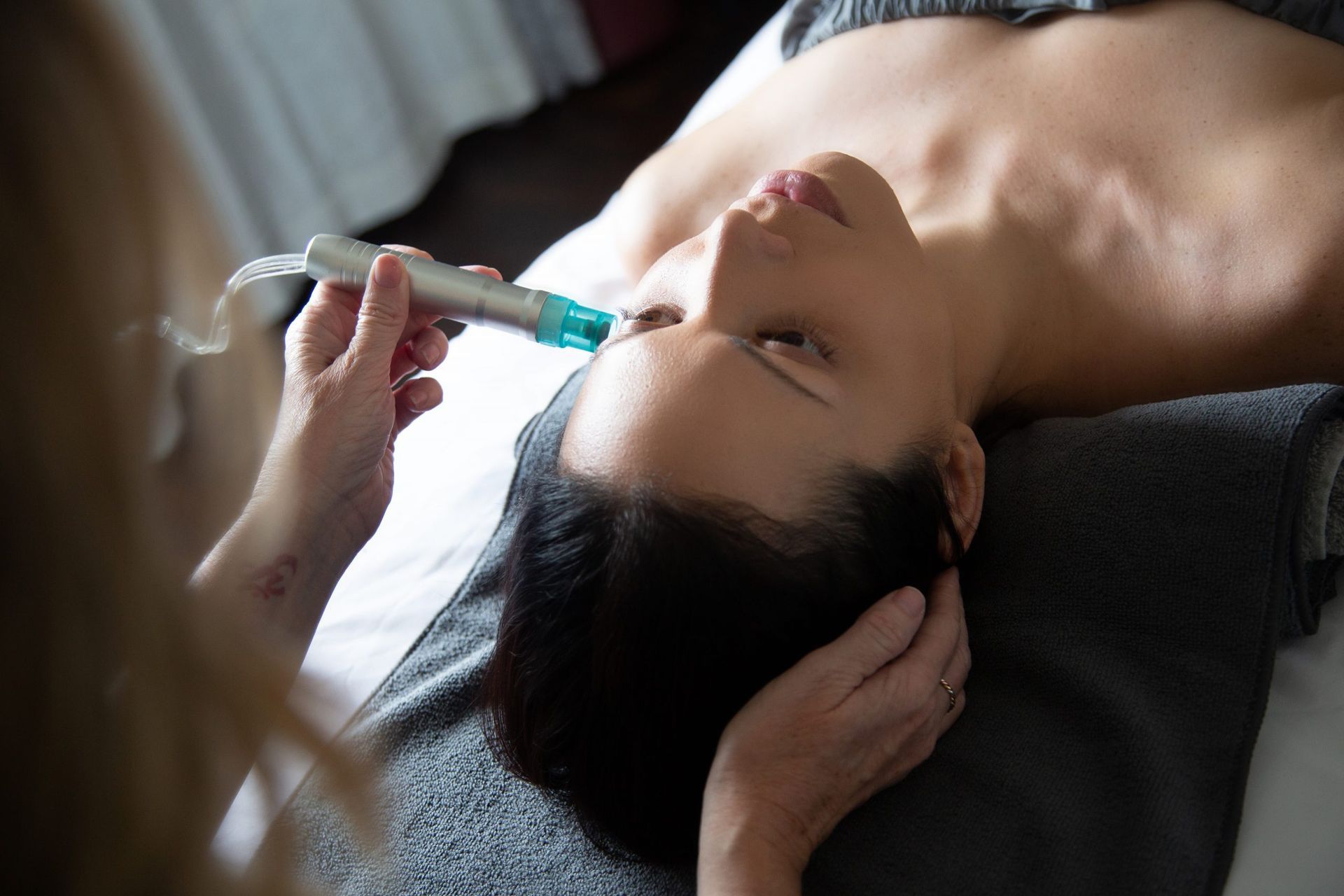 A woman is getting a facial treatment at a spa.