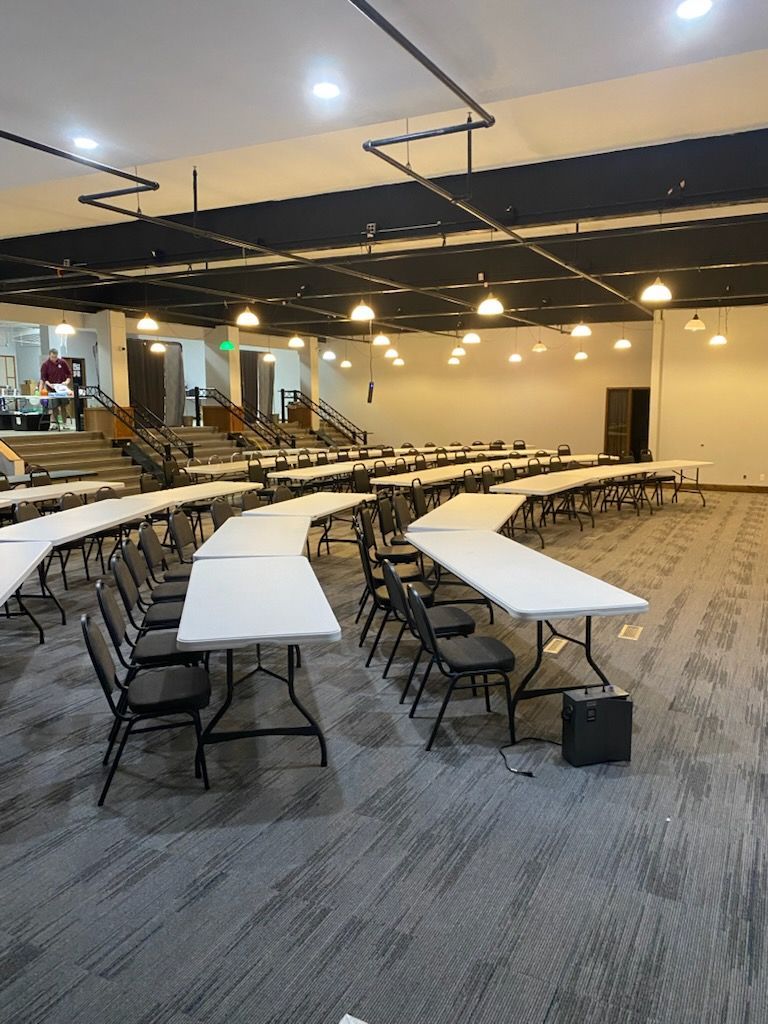 A large room with tables and chairs in it