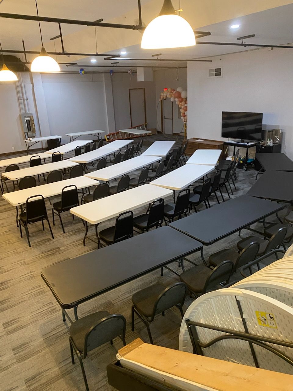 A large room filled with tables and chairs.