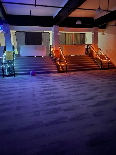 A large room with stairs and a ball on the floor