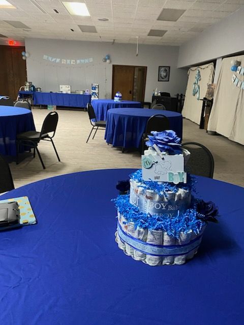 A diaper cake is on a table in a room