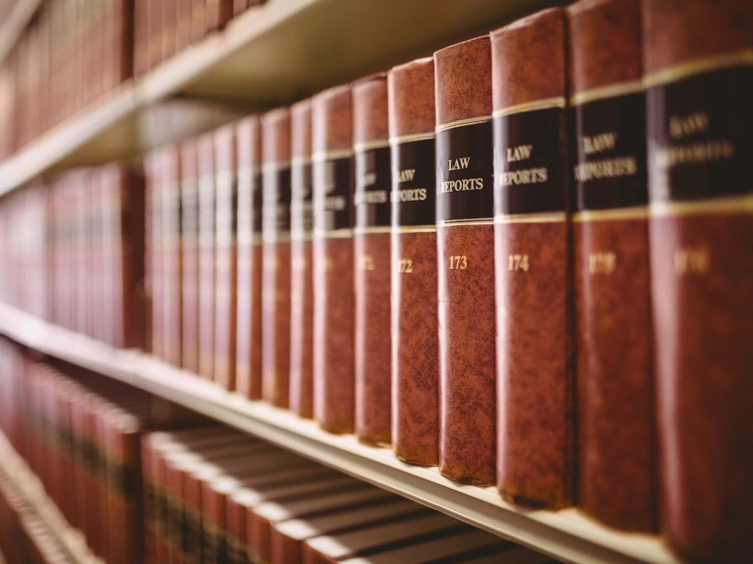 A row of law books on a shelf in a library.