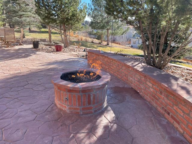 Fire Pit on a Patio Next to a Brick Wall — Centennial, CO — Colorado Curbing & Landscape