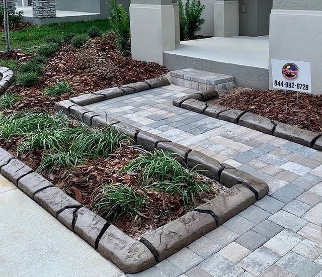 Stone paver walkway installed providing access from driveway to front door - Colorado Curbing and Landscape