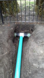 Green Pipe Installed In The Outside Of House — Northbrook, IL — Shelly’s Landscape 