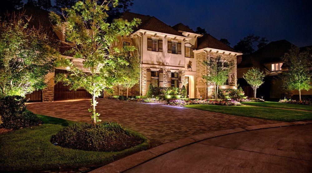 Luxury home landscape lighting in Buffalo Grove IL with illuminated trees, walkway, and front yard design by Shelly’s Landscape