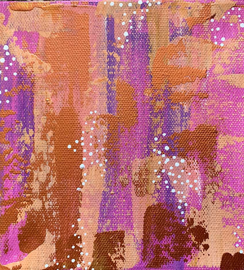 A close up of a purple and brown painting on a canvas.