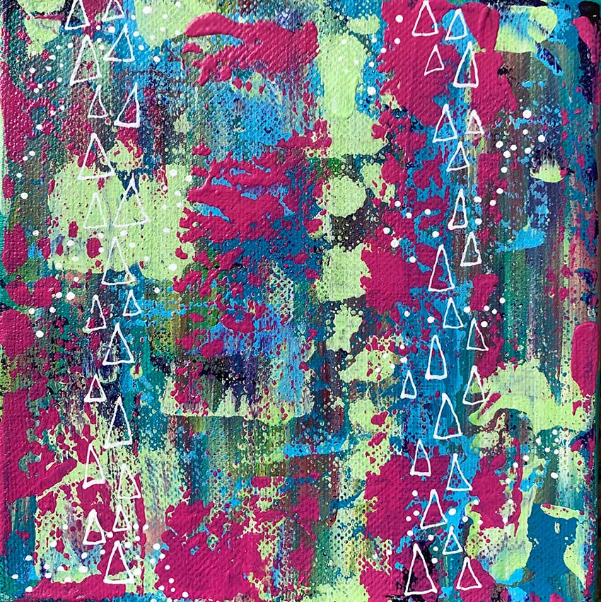 A close up of a colorful painting with triangles on it.