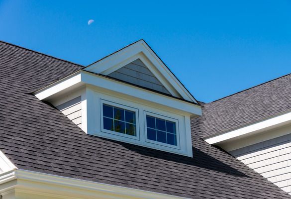 A house with an awning window on the roof.