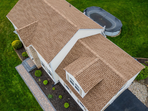An aerial view of a large house with a large driveway.