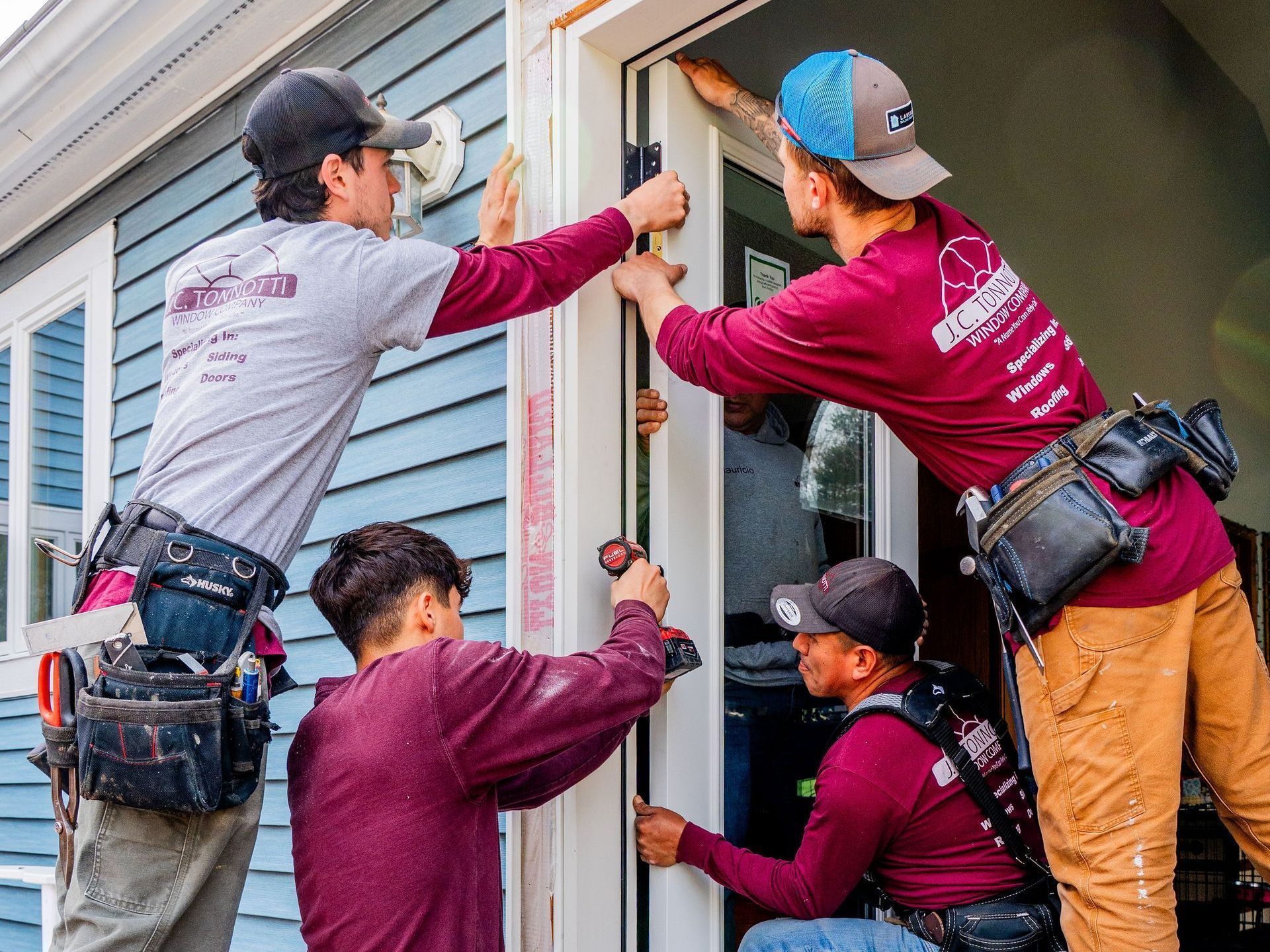 A group of men are working on a door.