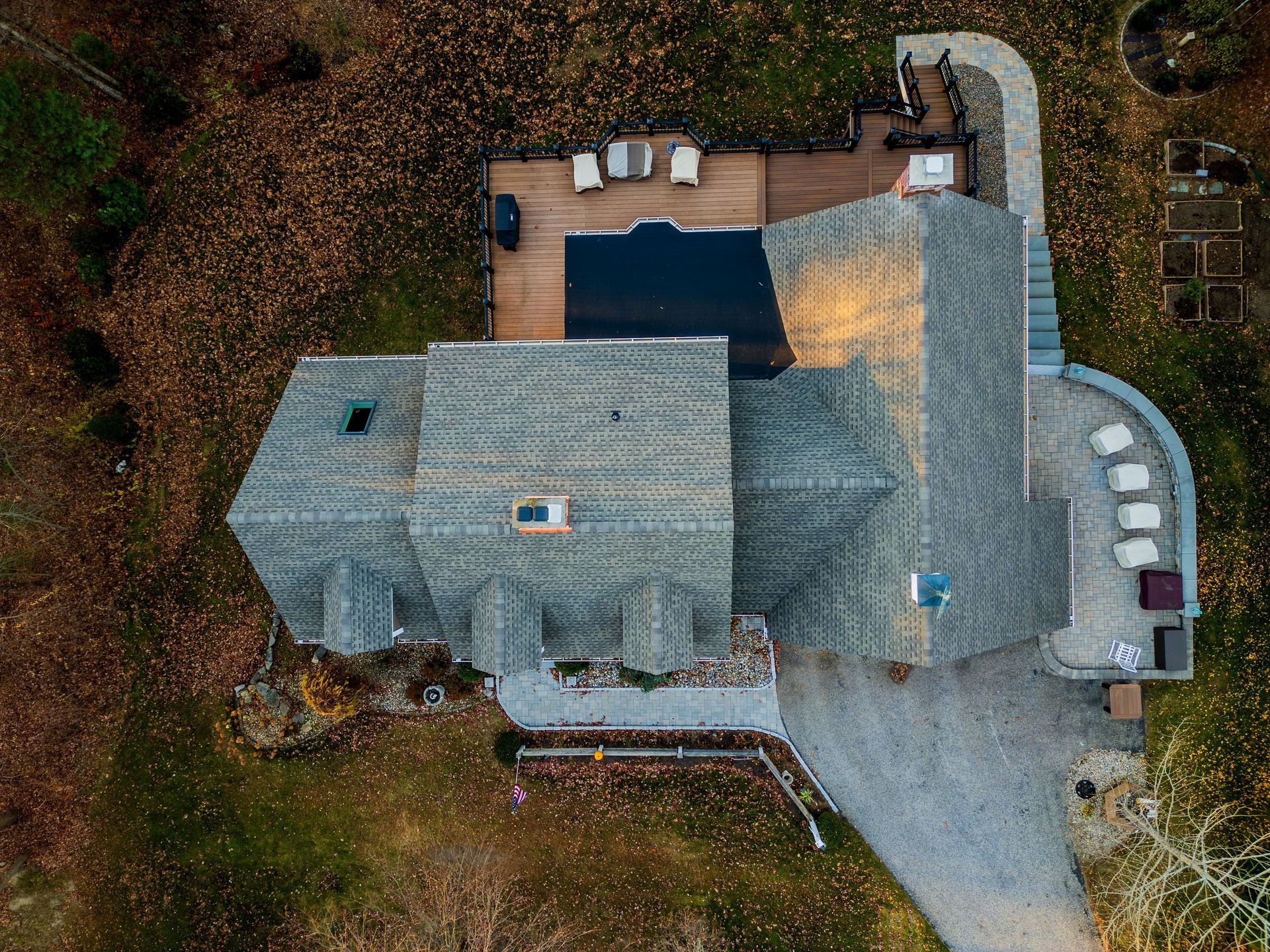 An aerial view of a large house with a large driveway.