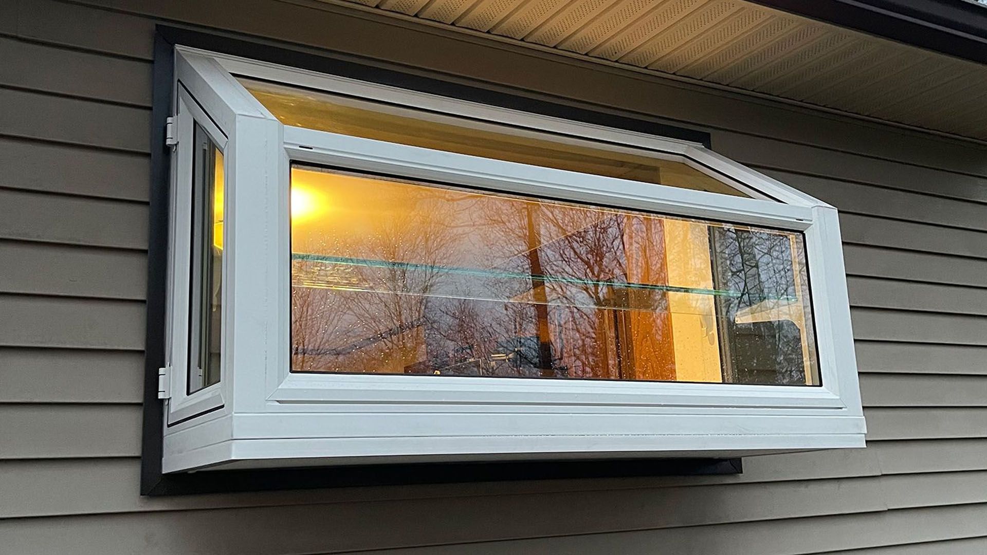 A large garden window on the side of a house.