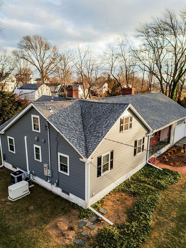 An aerial view of a house with a new roof.