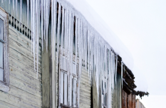 Icicles are hanging from the side of a building.