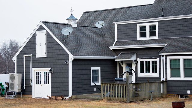 A large house with a satellite dish on the roof