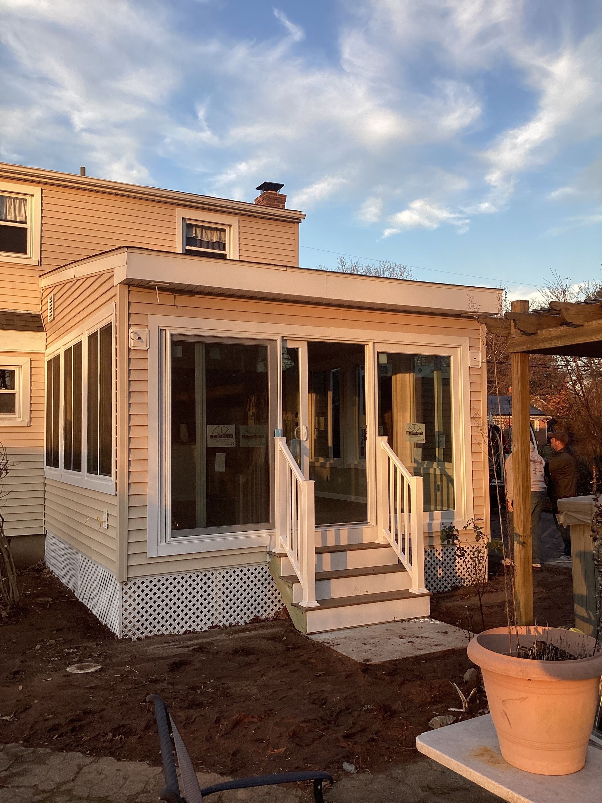A house with a screened in porch and stairs