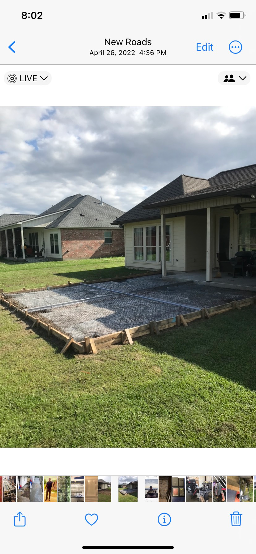 A picture of a patio being built in front of a house.