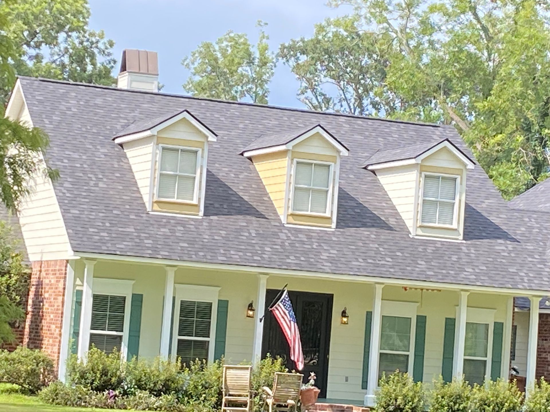 A house with a porch and a flag on it